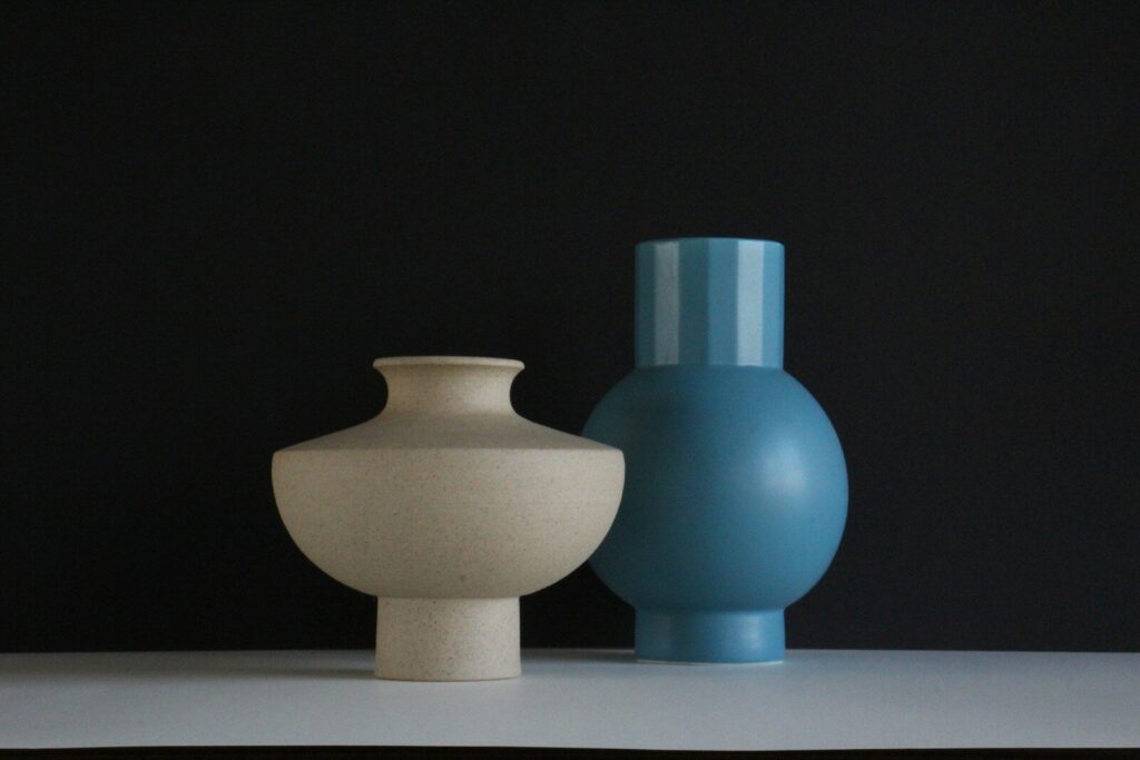 A couple of vases sitting on top of a table