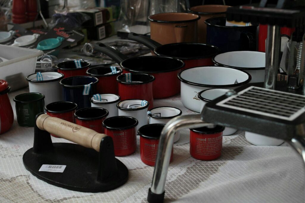 red ceramic mugs on stainless steel rack